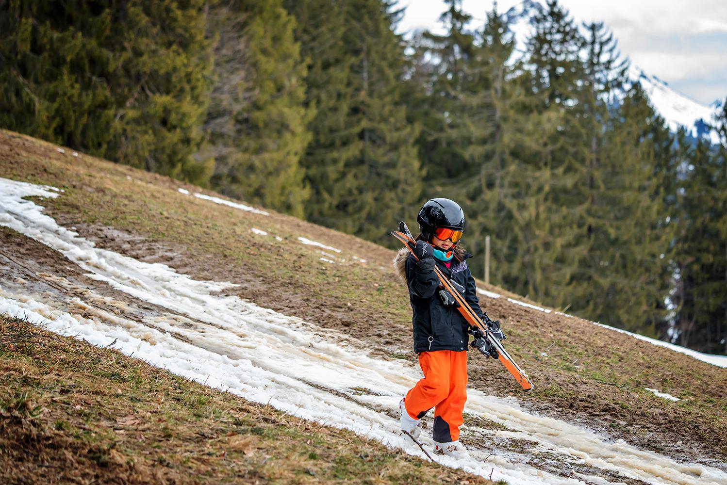 Child,Holding,Ski,And,Walking,On,Grass.,Problem,Of,Global